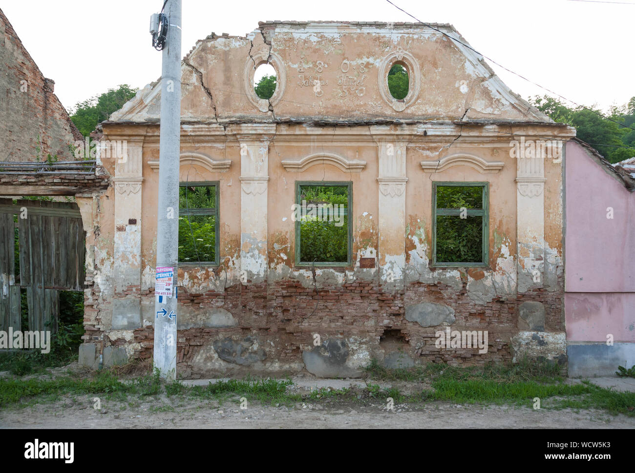 The decaying facade of an early 1800s house in the village of Richis, Transylvania, Romania Stock Photo