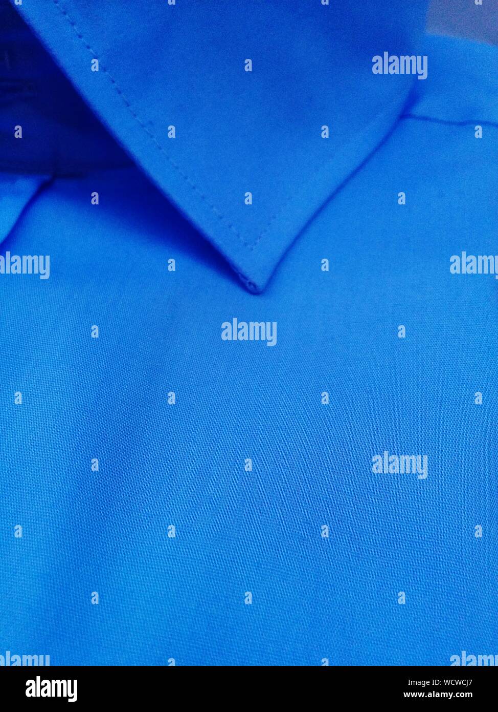 Close Up Of High Section Of Blue Shirt Stock Photo