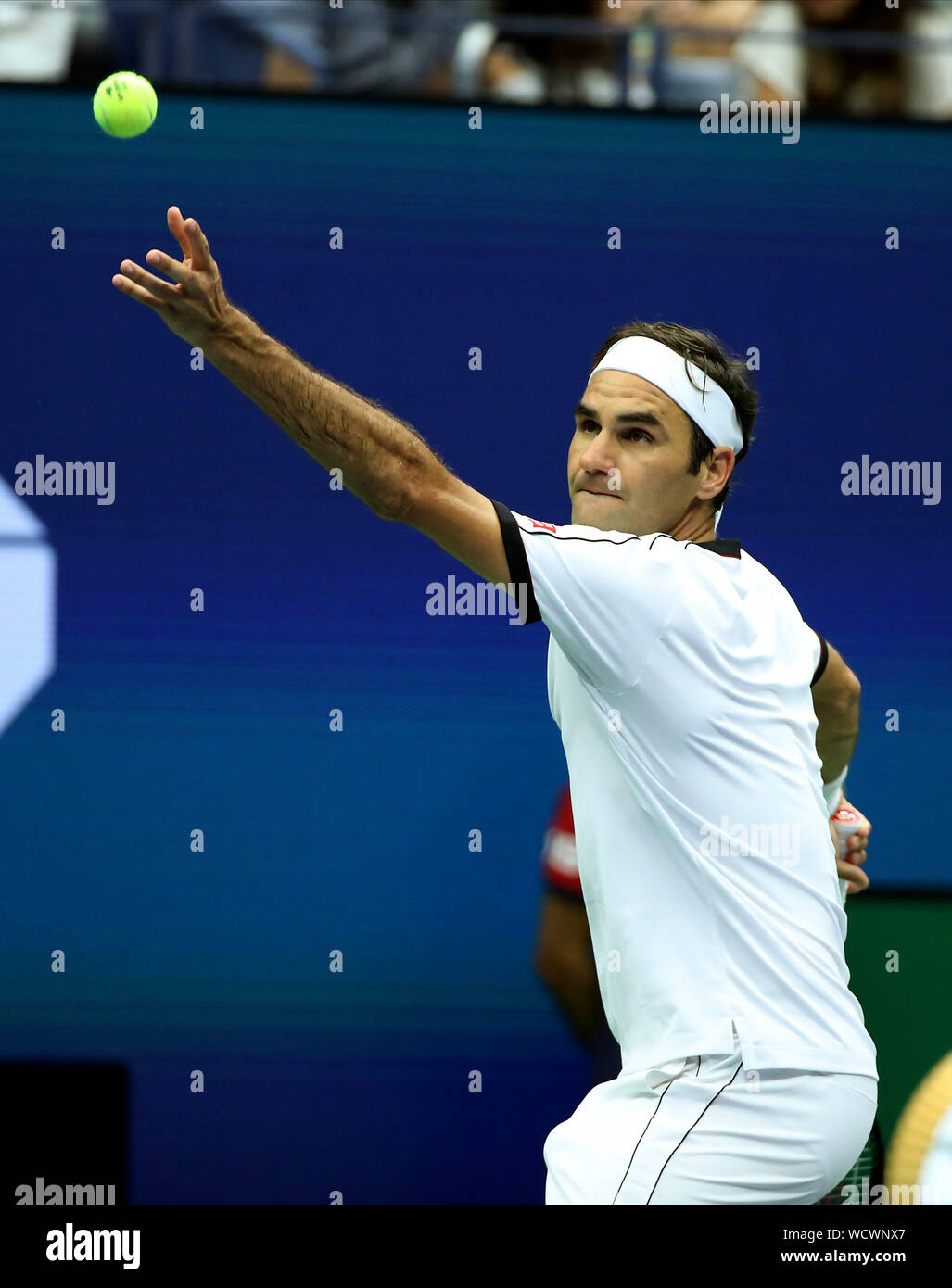Roger Federer of Switzerland serves to Damir Dzumhur of Bosnia and  Herzegovina in the second round match at the 2019 US Open Tennis  Championships at the USTA Billie Jean King National Tennis