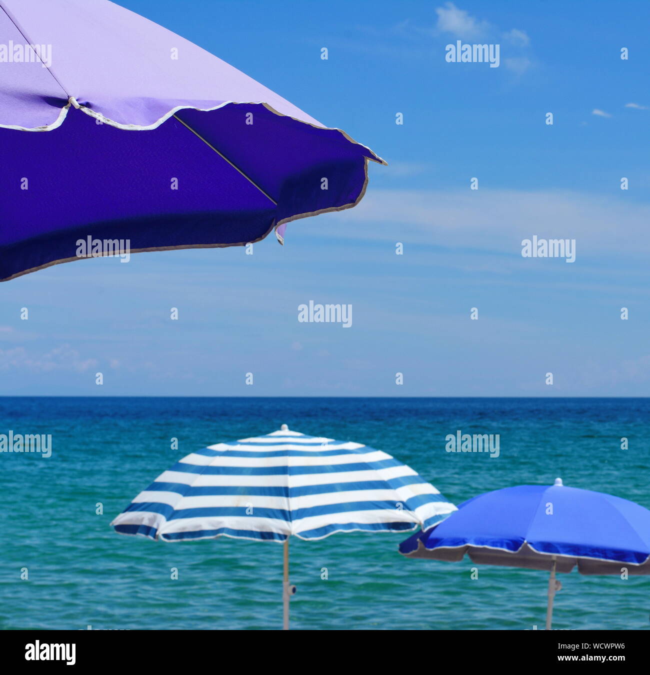 Beach umbrella near the water. Beach umbrella on the beach. Colorful