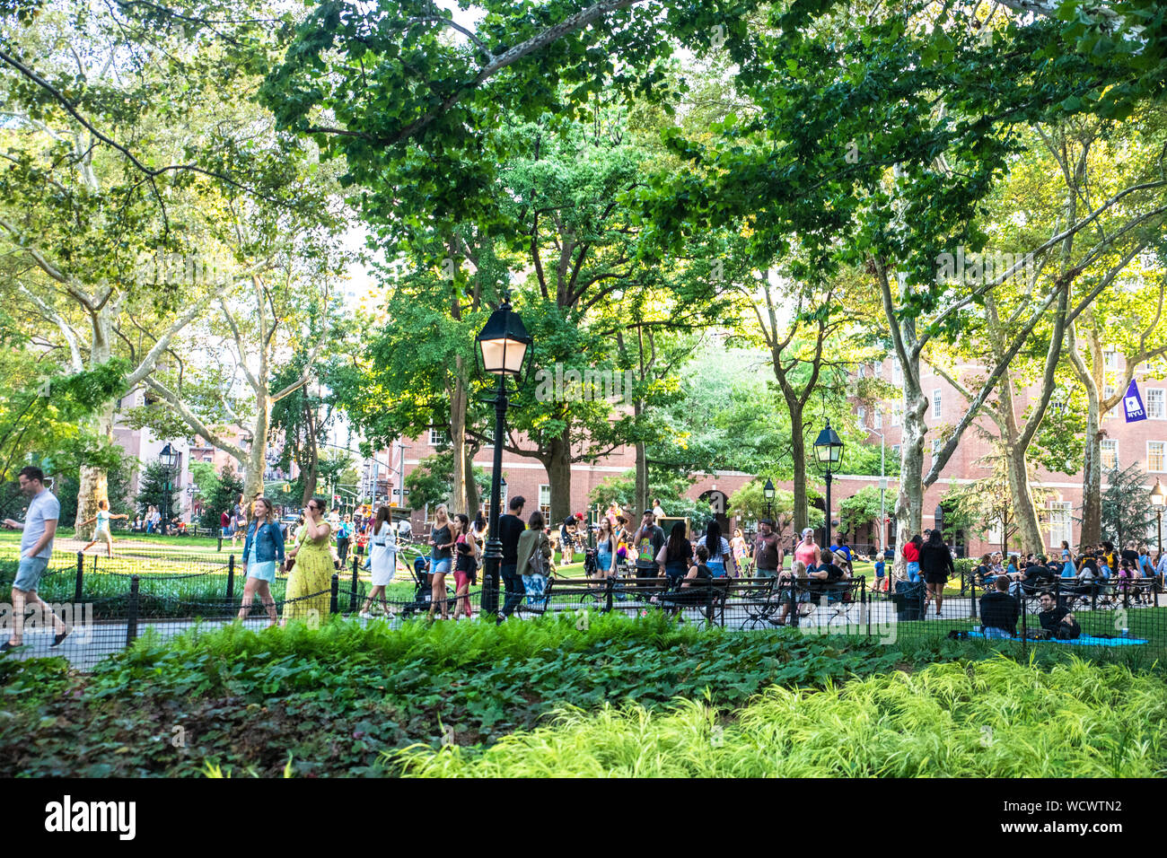 NEW YORK CITY - AUGUST 24, 2019:  View from Washington Square Park in Greenwich Village Manhattan on a summer afternoon.  People and NYU are visible. Stock Photo