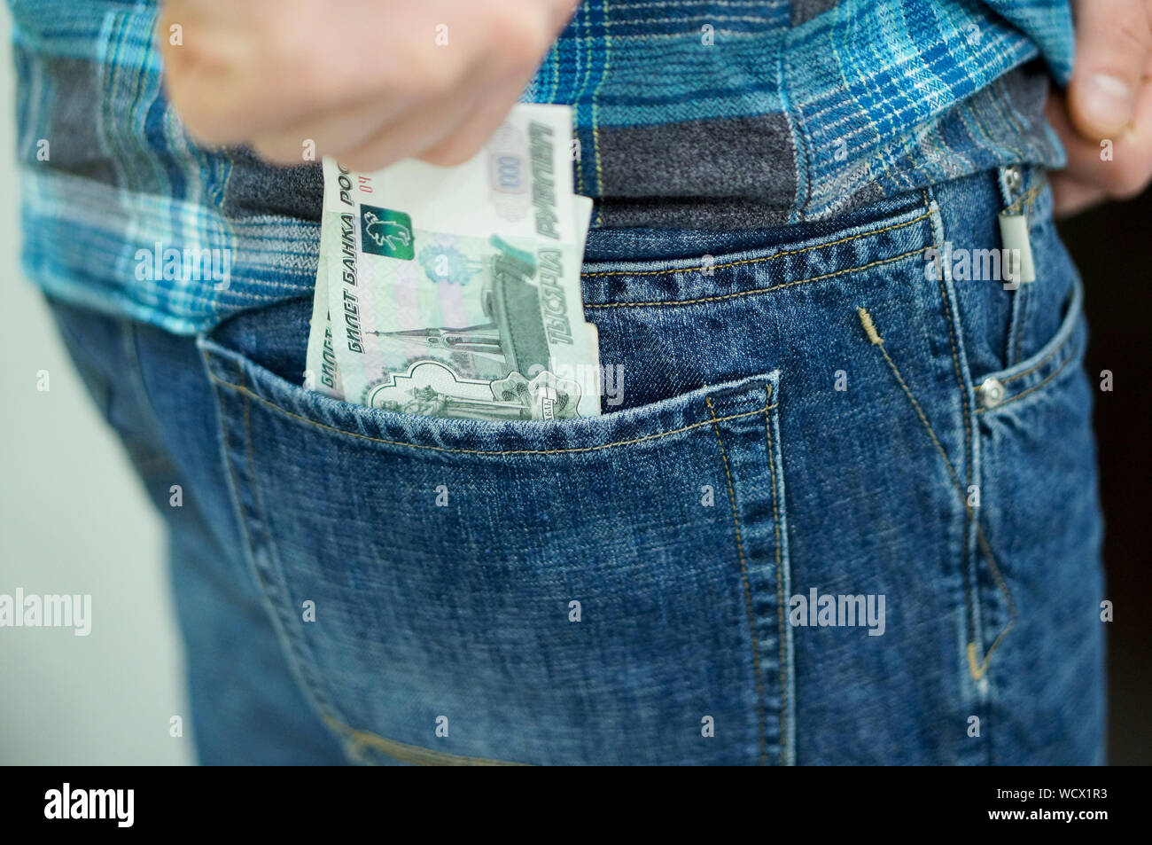 Midsection Of Man Keeping Money In Pocket Stock Photo