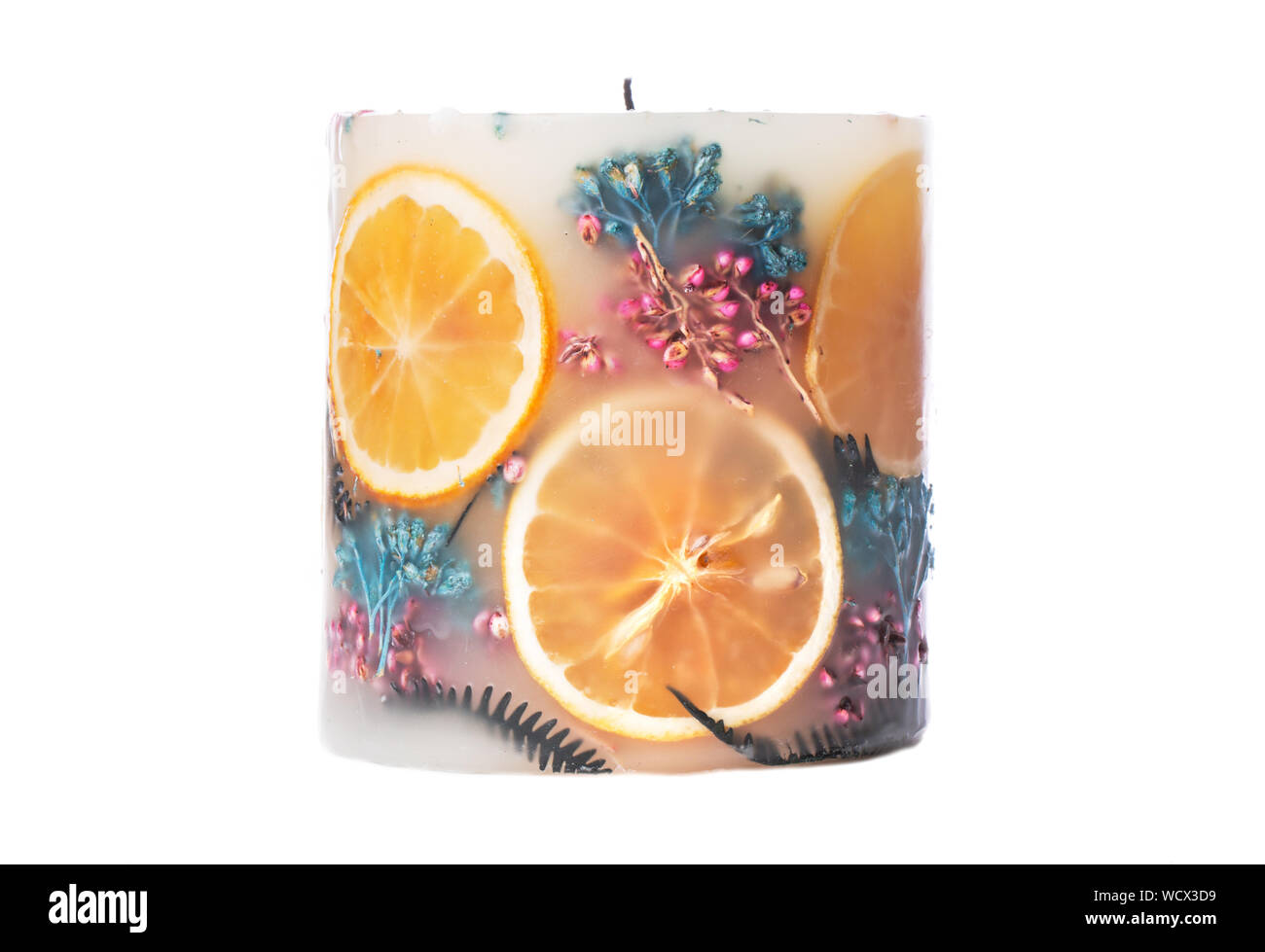 Large aromatic decorative candle with a herbarium of dried herbs and