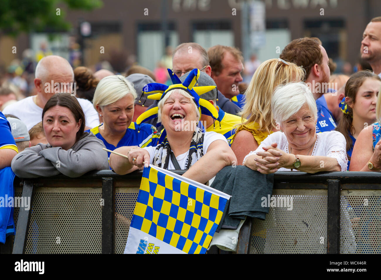 Warrington Wolves bring the Coral Challlenge Cup back home-supporters lean on the fence and show different emotions Stock Photo