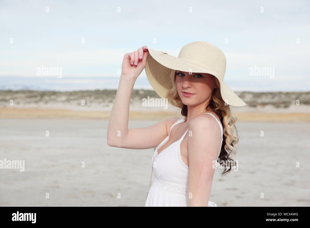 Portrait Of Beautiful Young Woman Wearing Sun Hat While Standing On ...