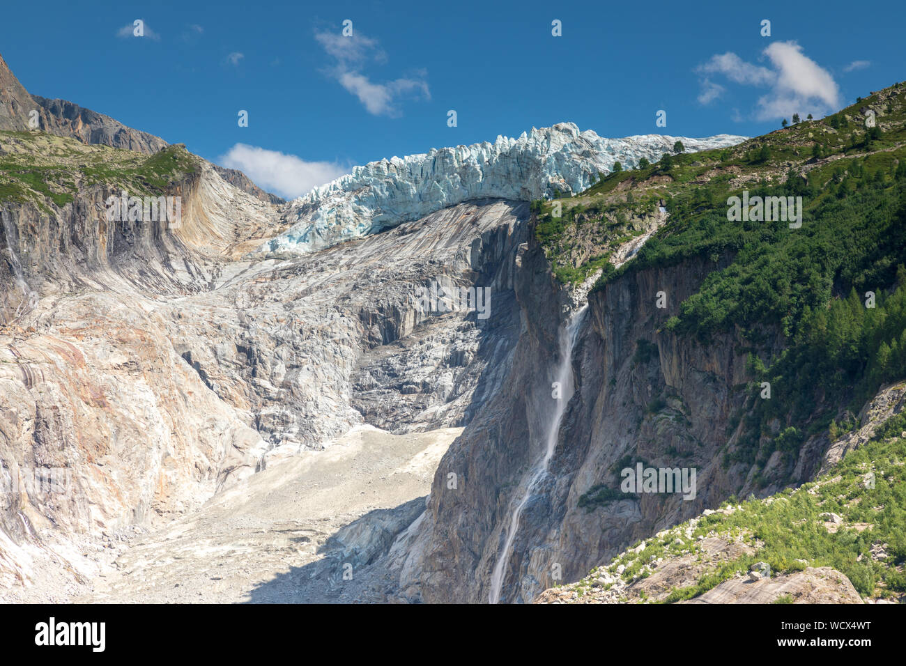 Argentiere glacier from the viewpoint at Pierre a bossons in Argentiere.  The glacier has retreated in the rocky moraine field. Stock Photo