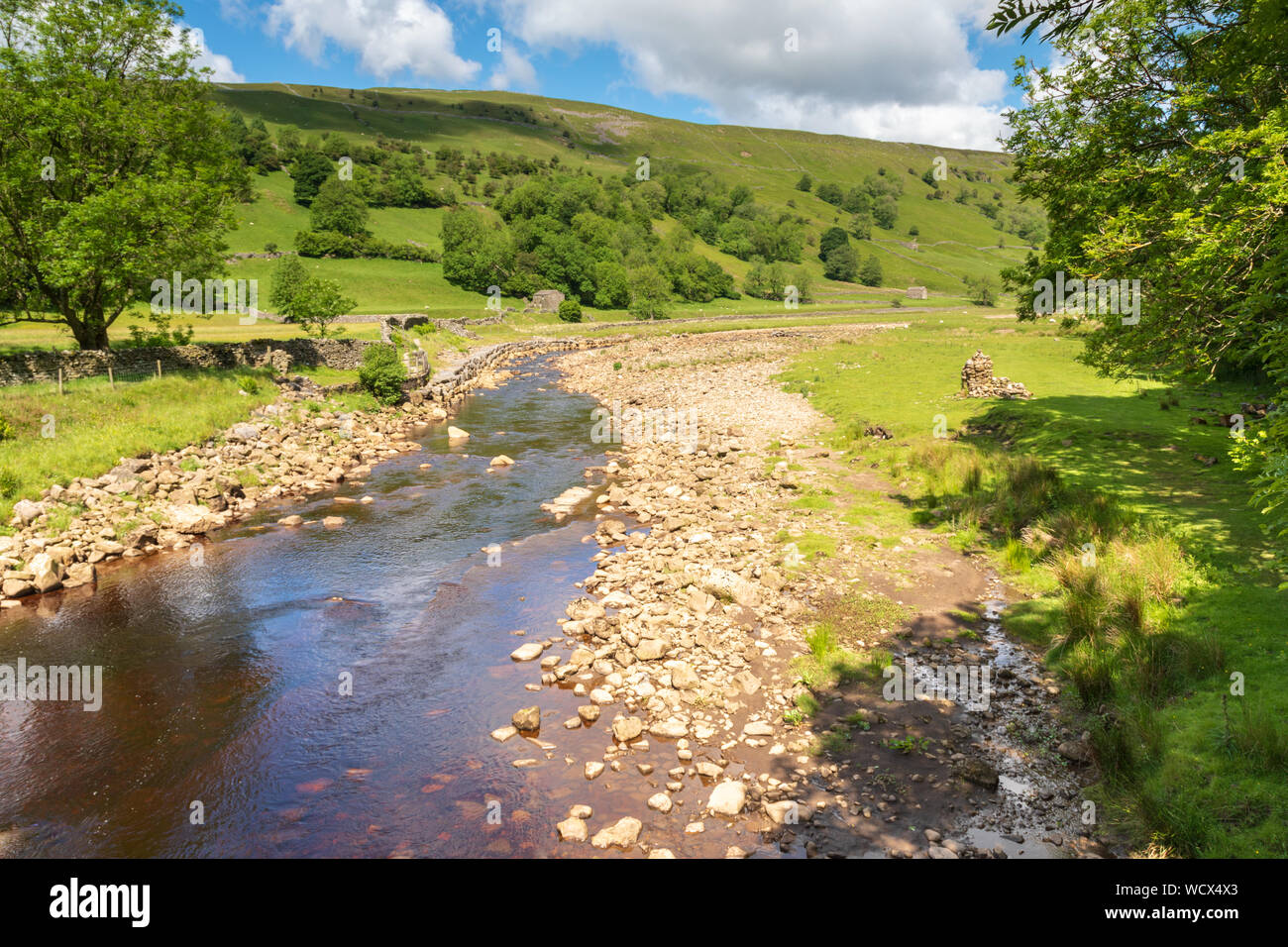 River Swale in Upper Swaledale from Rampsholm bridge looking towards the footpath to Keld and Kisdon Hill. Stock Photo