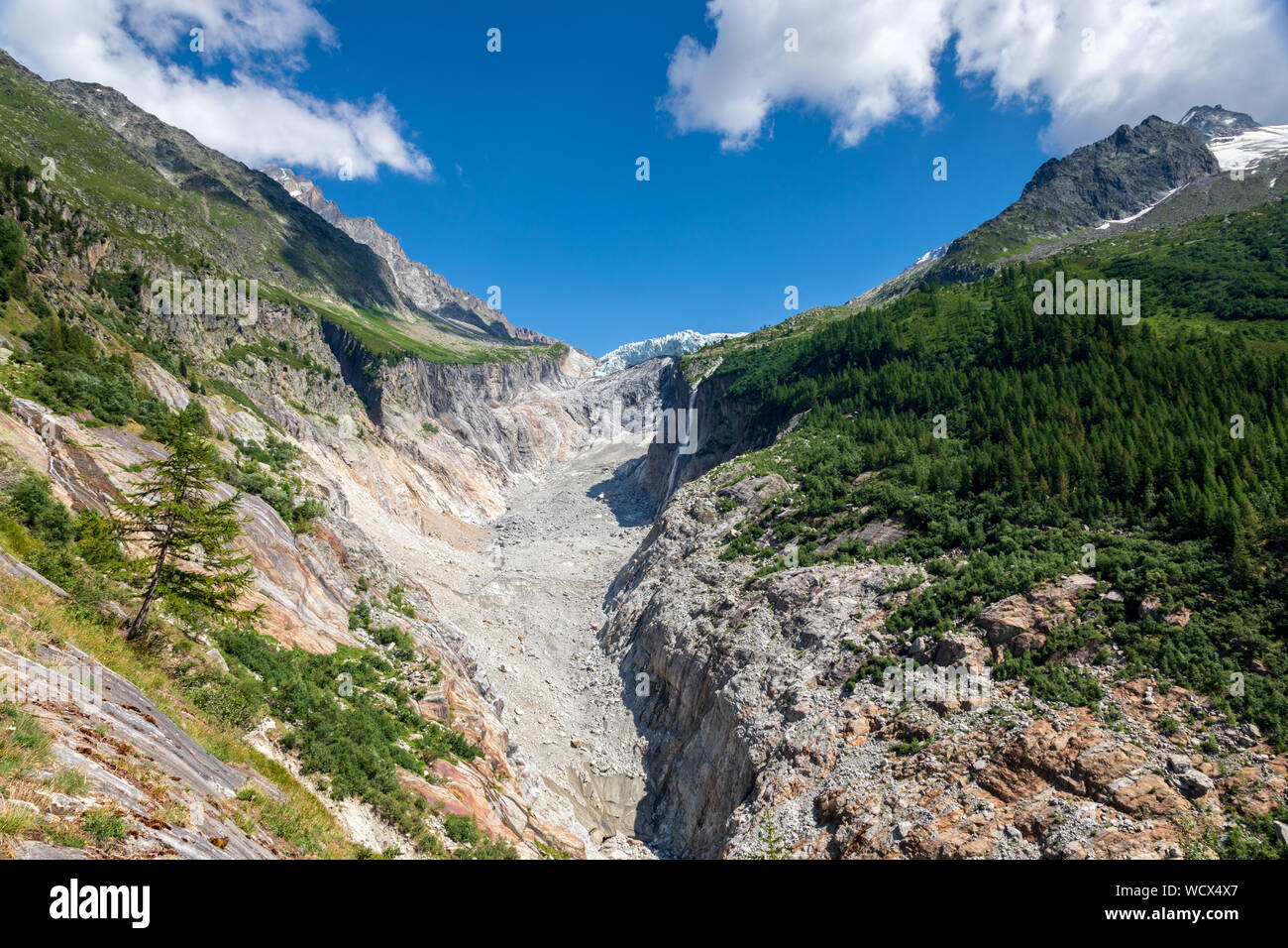 Argentiere glacier from the viewpoint at Pierre a bossons in Argentiere.  The glacier has retreated in the rocky moraine field. Stock Photo