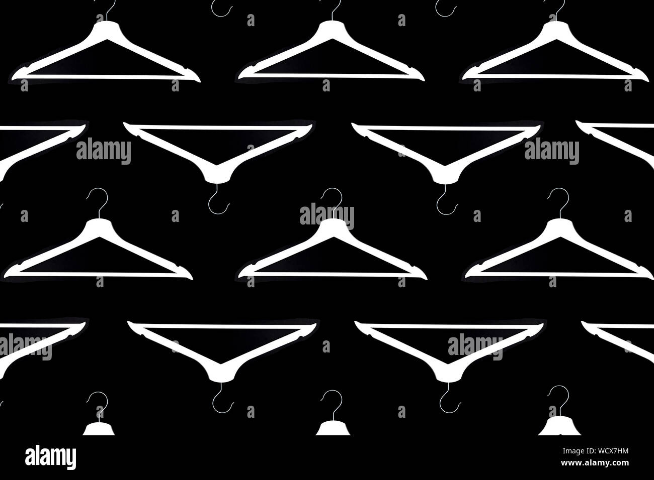 Fashion clothes hanger pattern on black background. Stock Photo