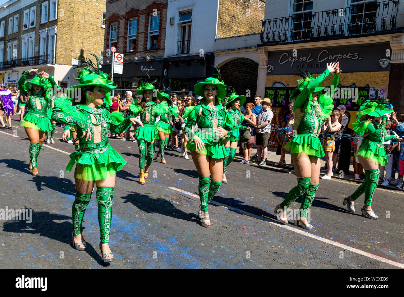 26 August 2019 - Women dressed up in green costumes dancing in the parade, Notting Hill Carnival on a hot Bank Holiday Monday, London, UK Stock Photo