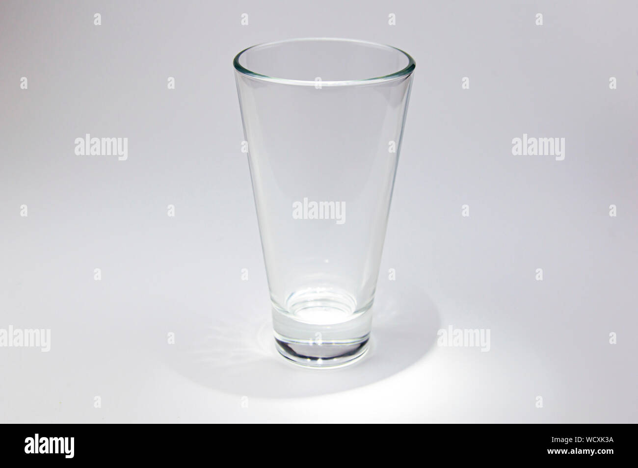 Empty glass transparent glass with color illumination. Background image ...