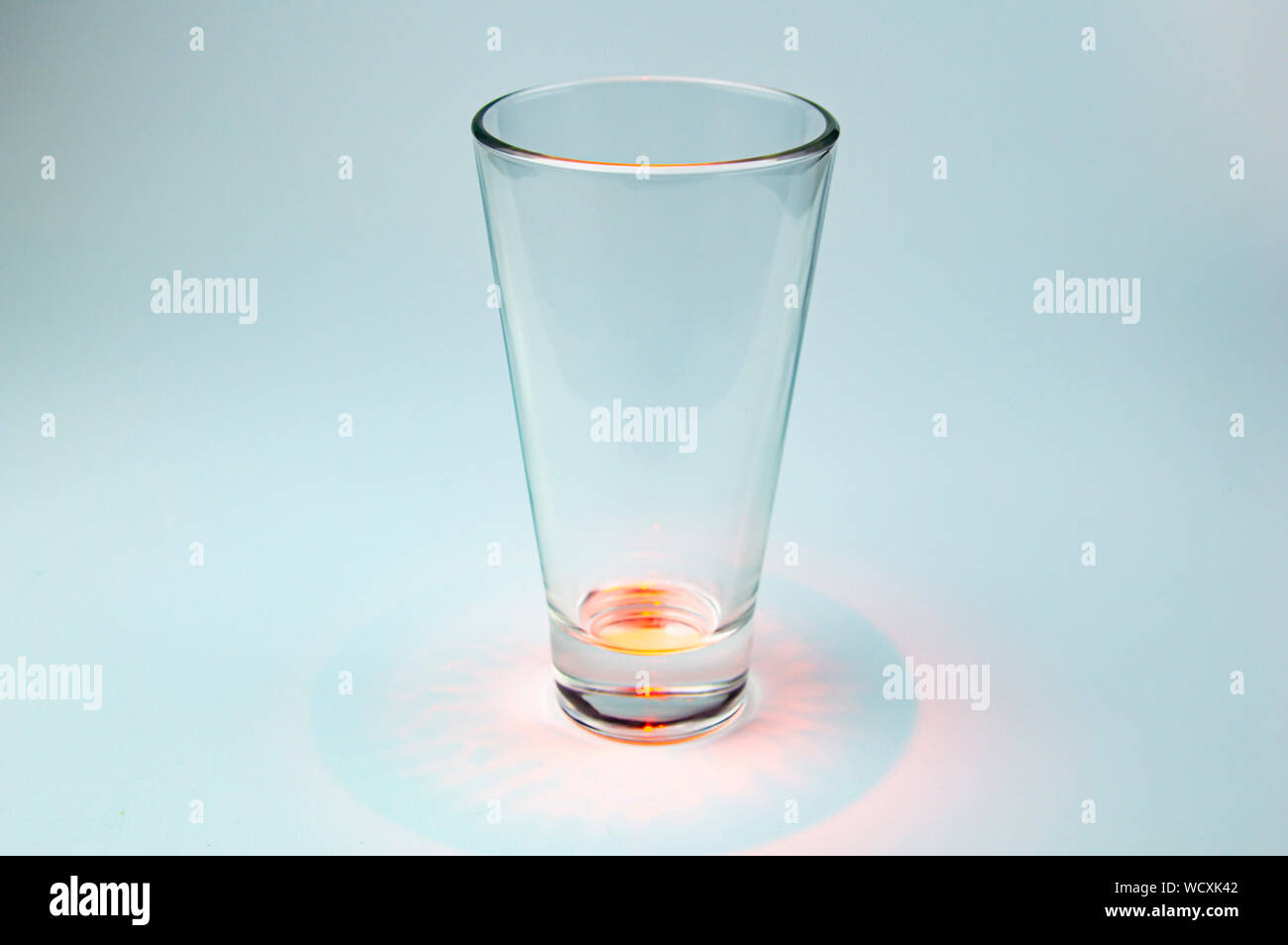 Empty glass transparent glass with color illumination. Background image ...