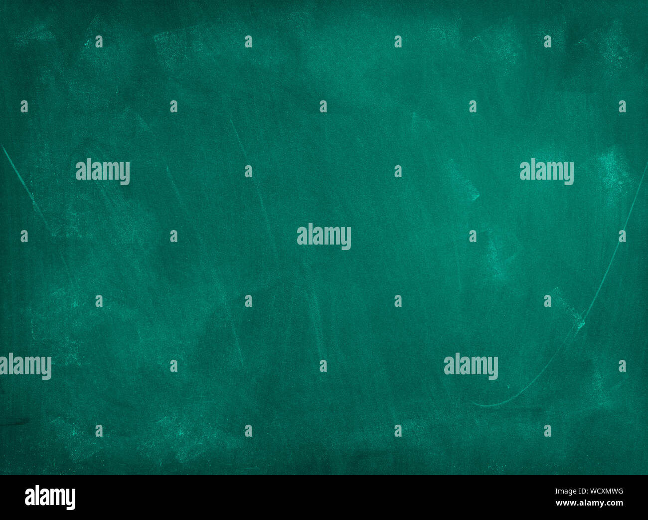 Chalk rubbed out on green chalkboard background Stock Photo