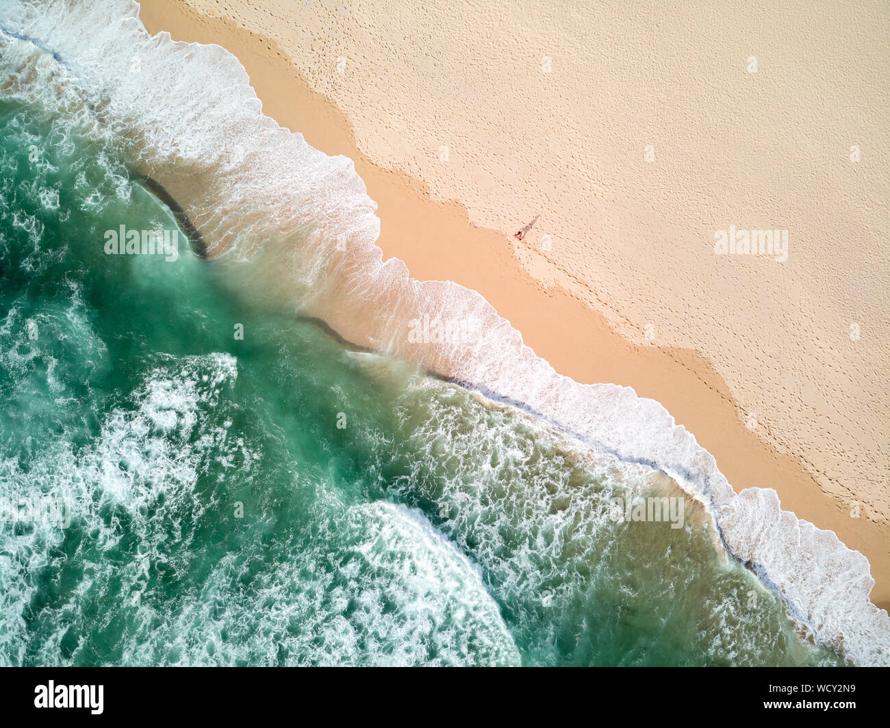 Aerial Photography of Ocean With Person Walking on Beach Stock Photo