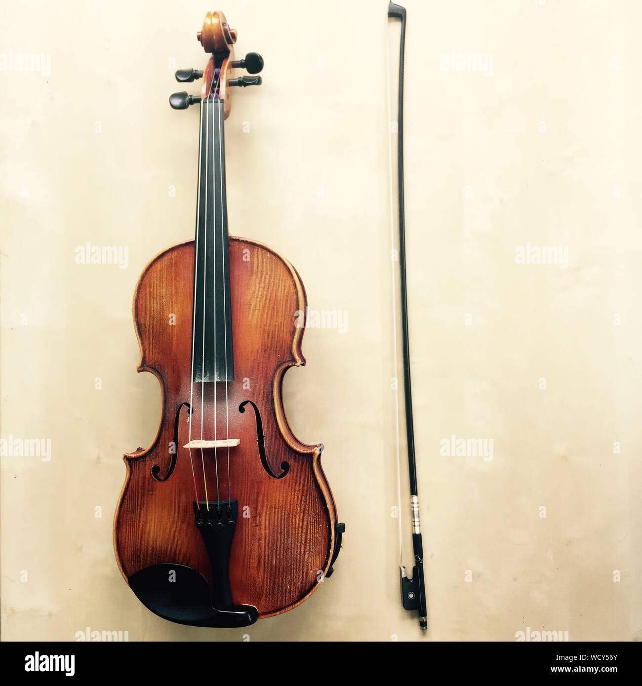 High Angle View Of Violin And Bow On Table Stock Photo