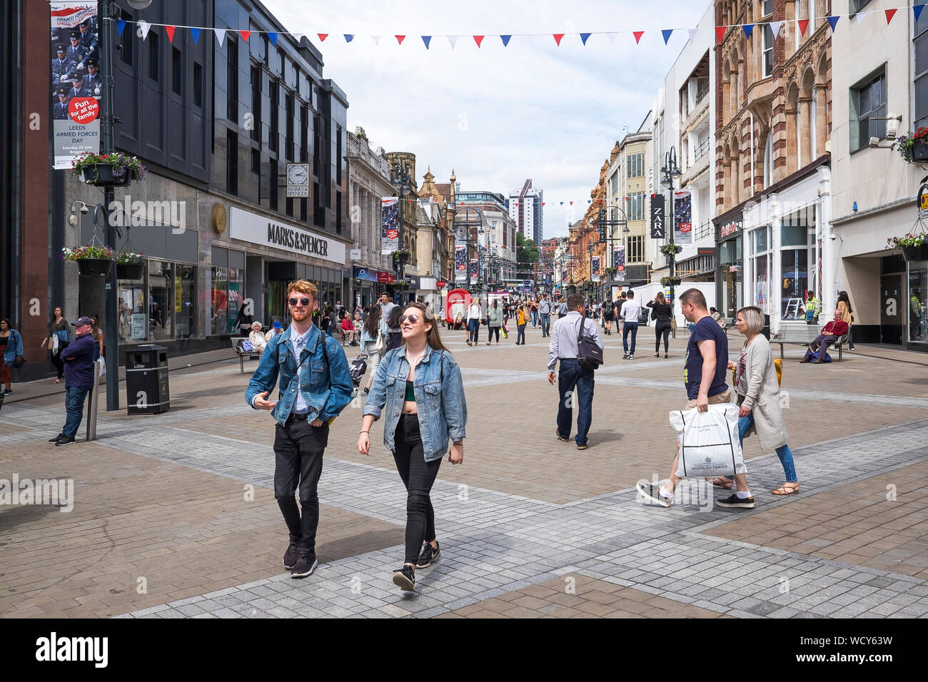 Shoppers on pedestrian UK high street. Briggate Leeds, West Yorkshire, England Stock Photo