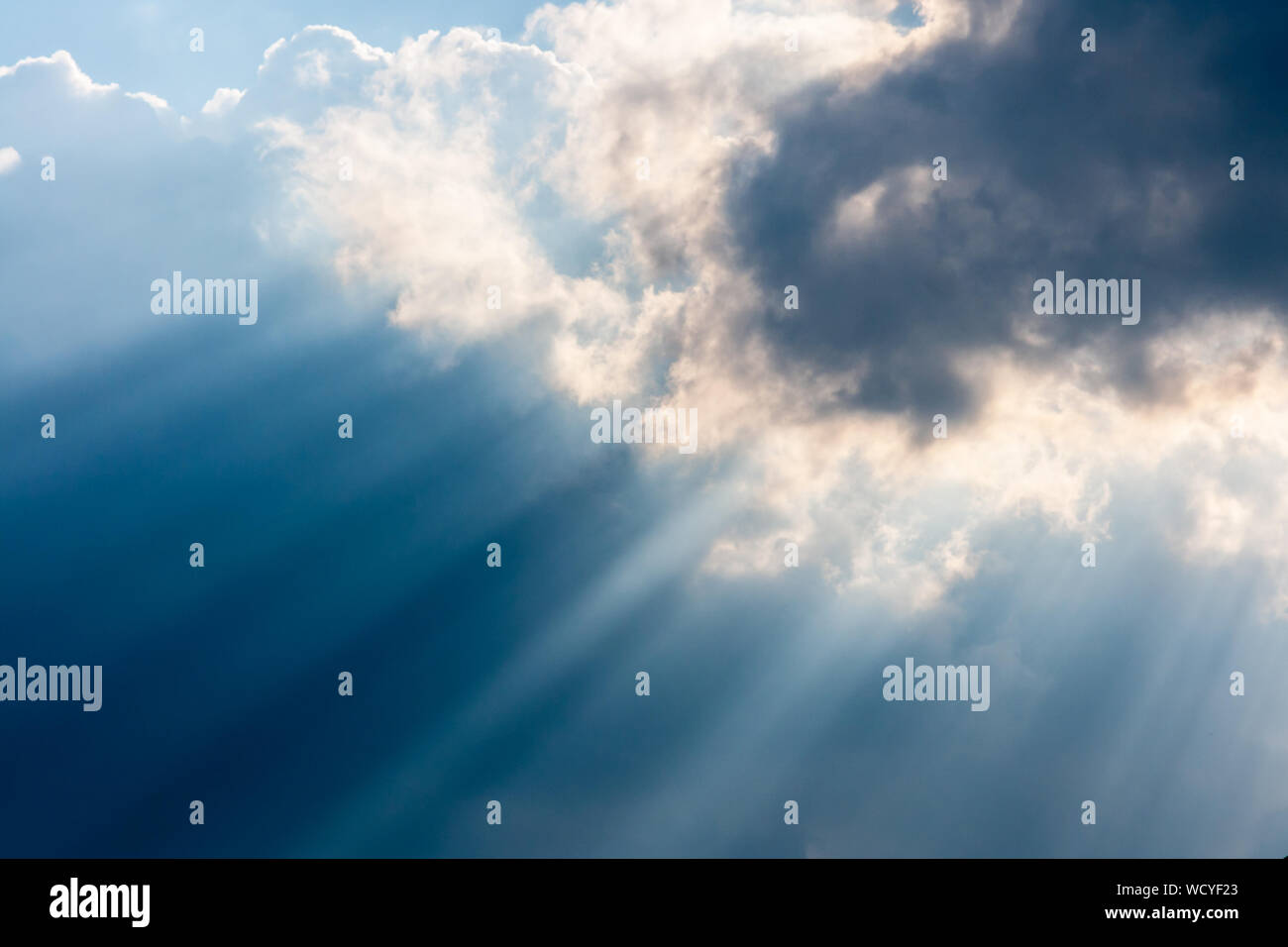 Low Angle View Of Sunbeam Streaming Through Cloud Stock Photo