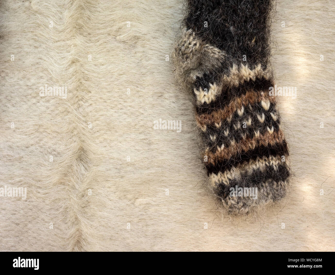 High Angle View Of Sock On Woolen Blanket Stock Photo