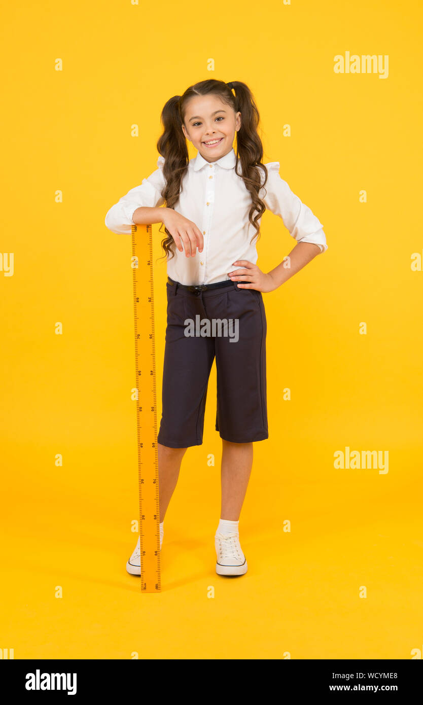 Time for learning. Small school child with ruler learning maths and ...