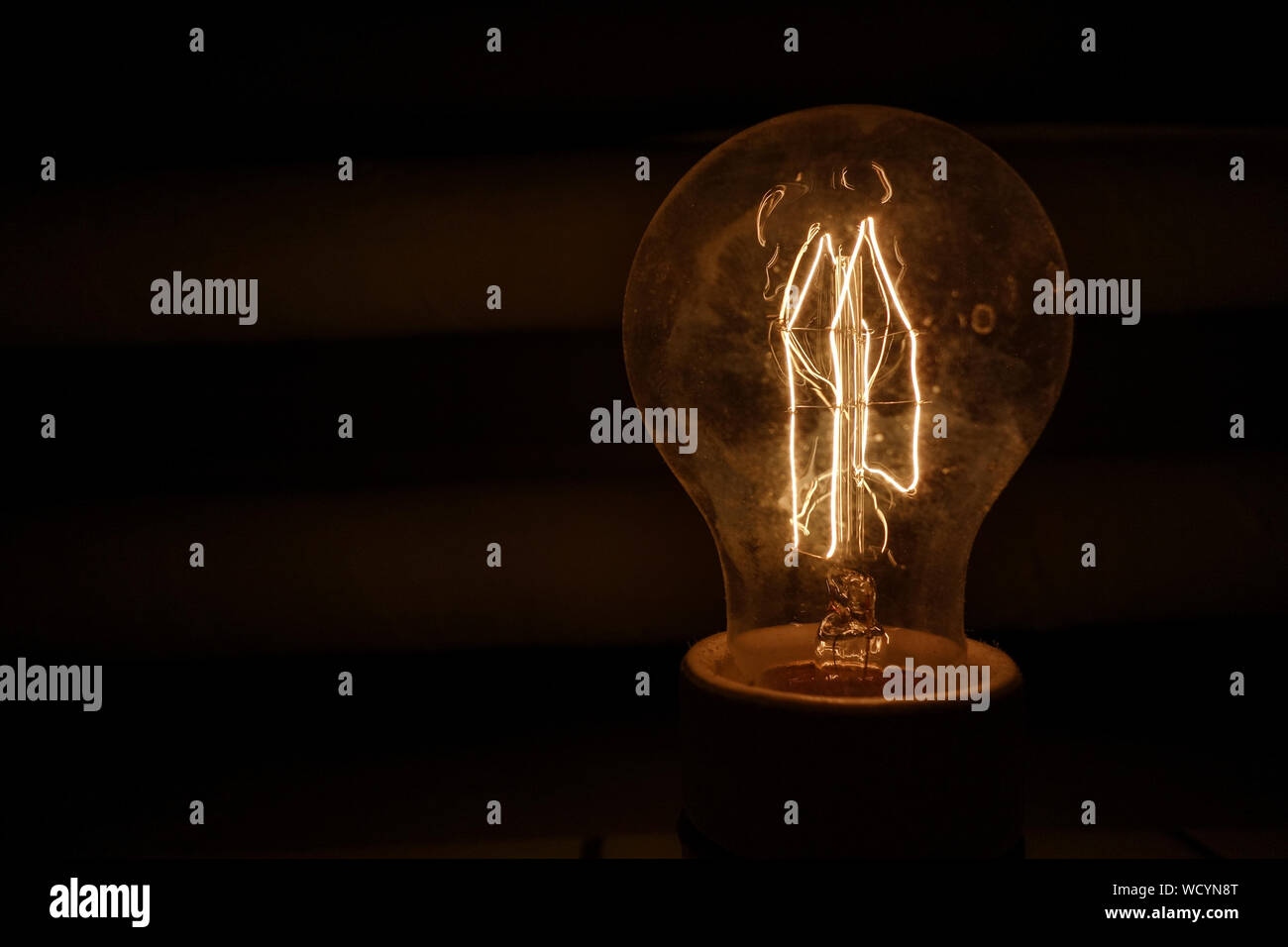 Closeup Of Illuminated Light Bulb In Darkroom Stock Photo Alamy