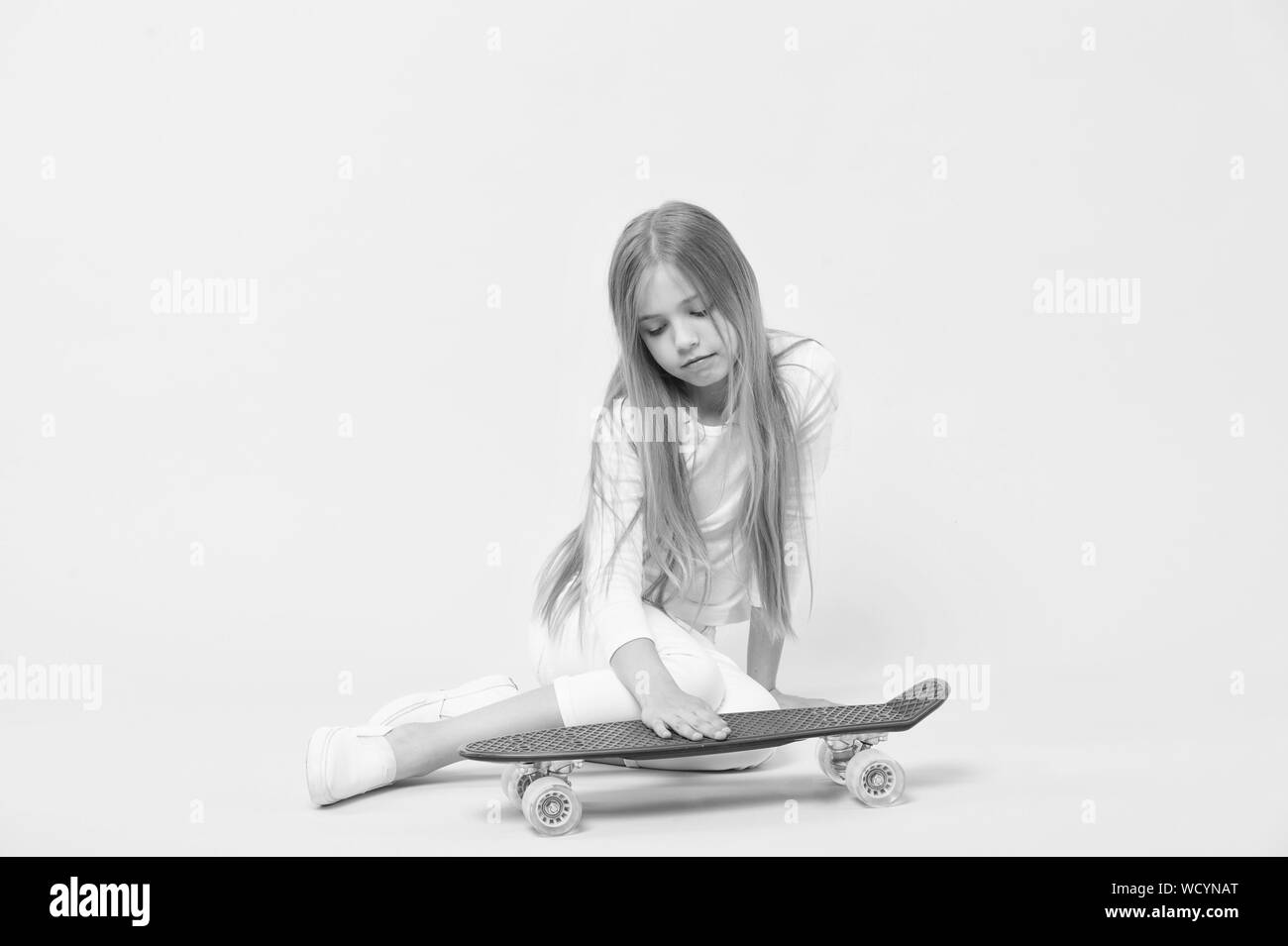 Loving Her Penny Board Little Girl Putting Hand On Board Deck On Pink Background Adorable Small Skater With Violet Penny Board Performing Tricks With The Skate Board Stock Photo Alamy