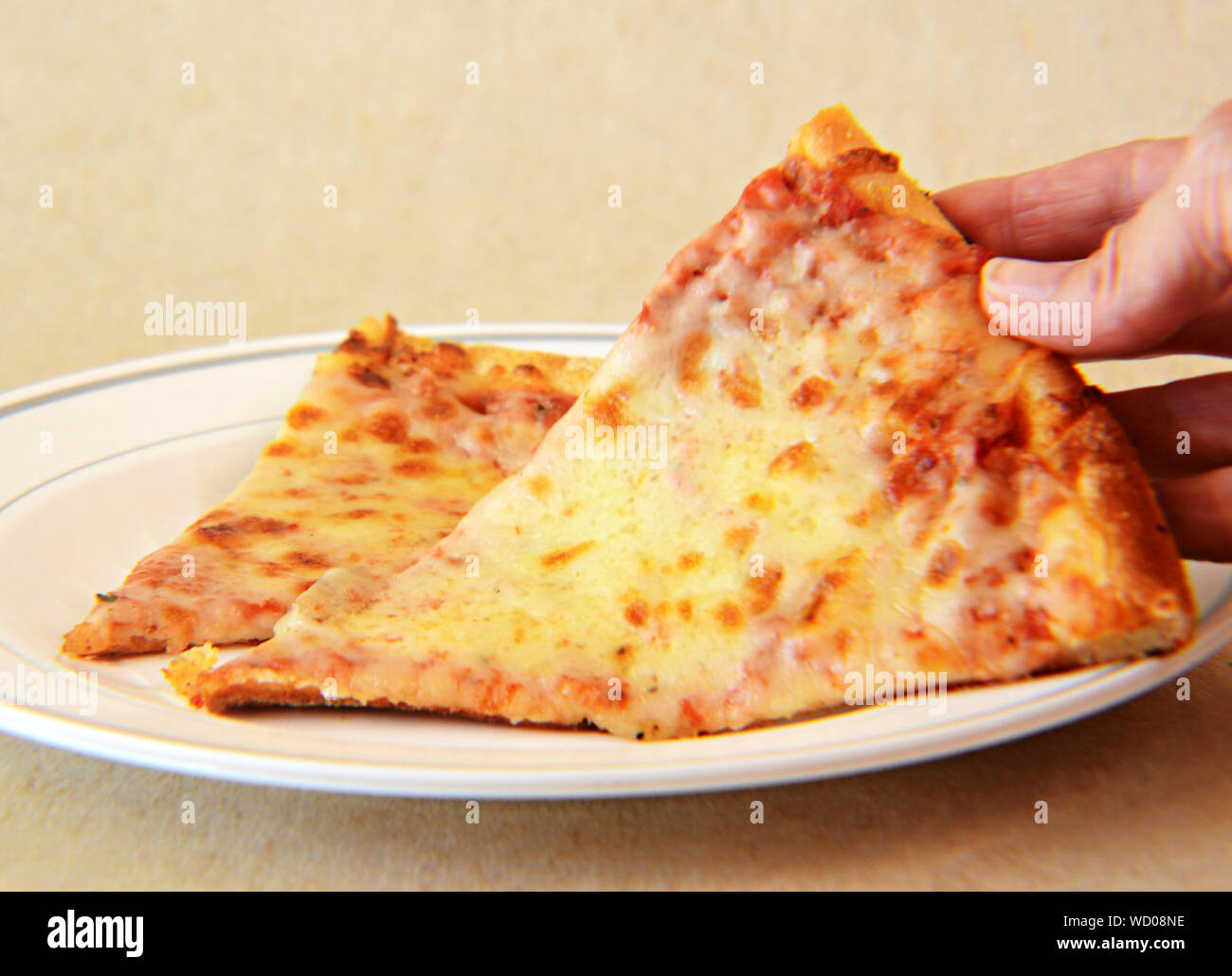 Cropped Hand Of Woman Holding Pizza Slice In Plate On Table Stock Photo Alamy