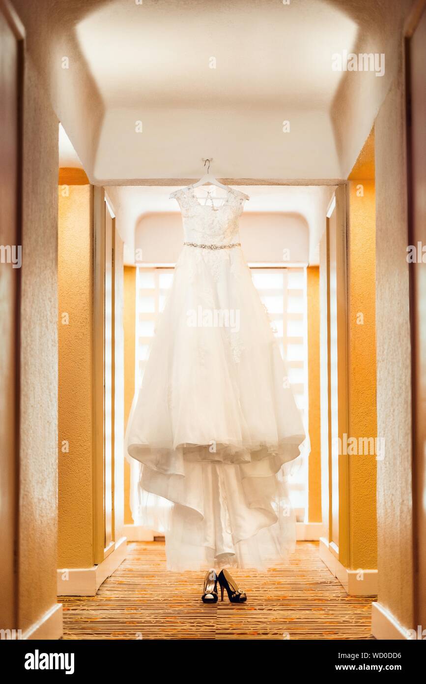 Vertical shot of a beautiful wedding gown on a stand with a pair of black high heels below Stock Photo - Alamy Vertical shot of a beautiful wedding gown on a stand with a pair of black high heels below Stock Photo - Alamy