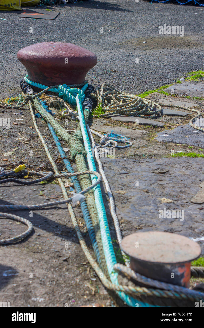 A iron cast mooring bollard and ropes on the quayside at Ardglass Harbour Northern Ireland Stock Photo
