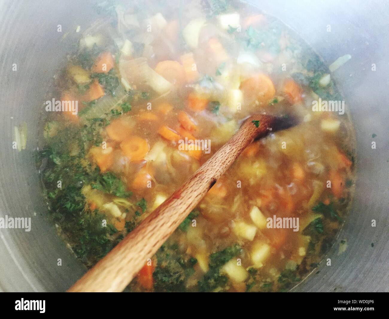 Directly Above Shot Of Soup And Spoon In Container Stock Photo