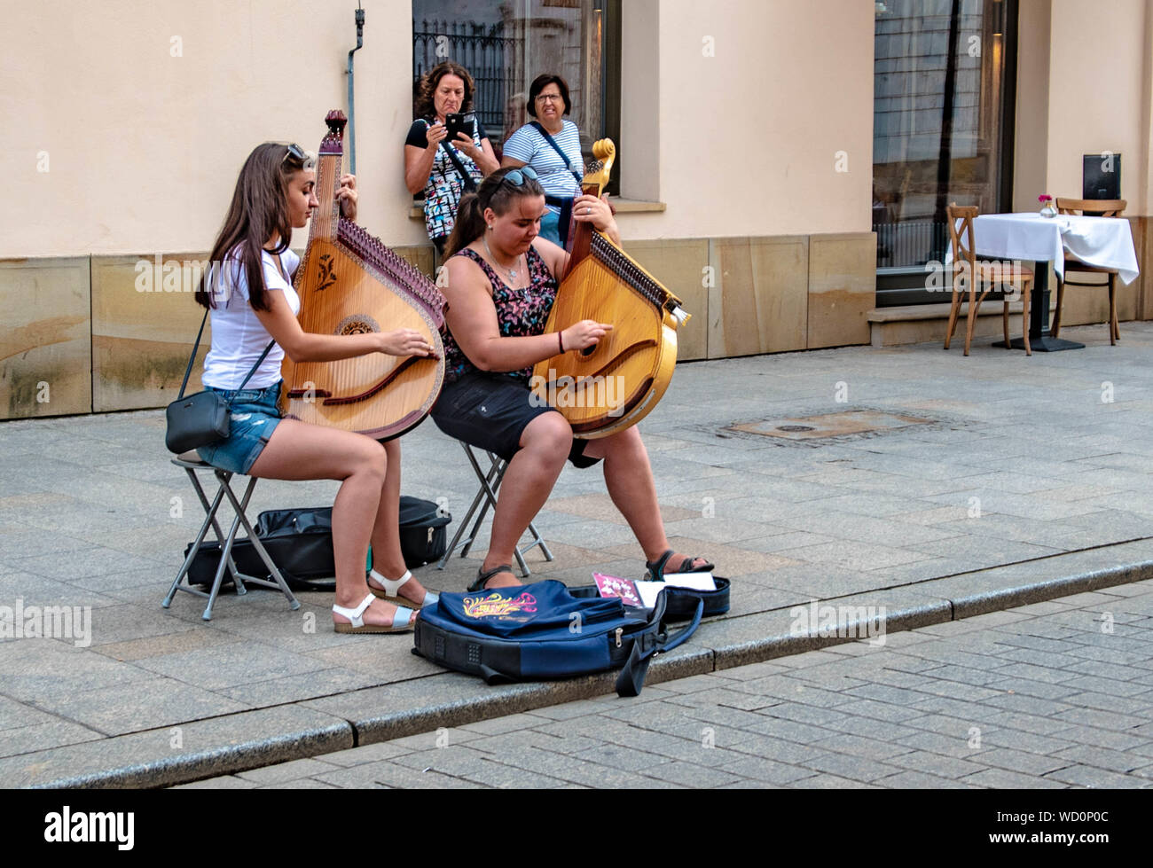 Two youths playing the Bandura on the streets of Krakow Poland Stock Photo