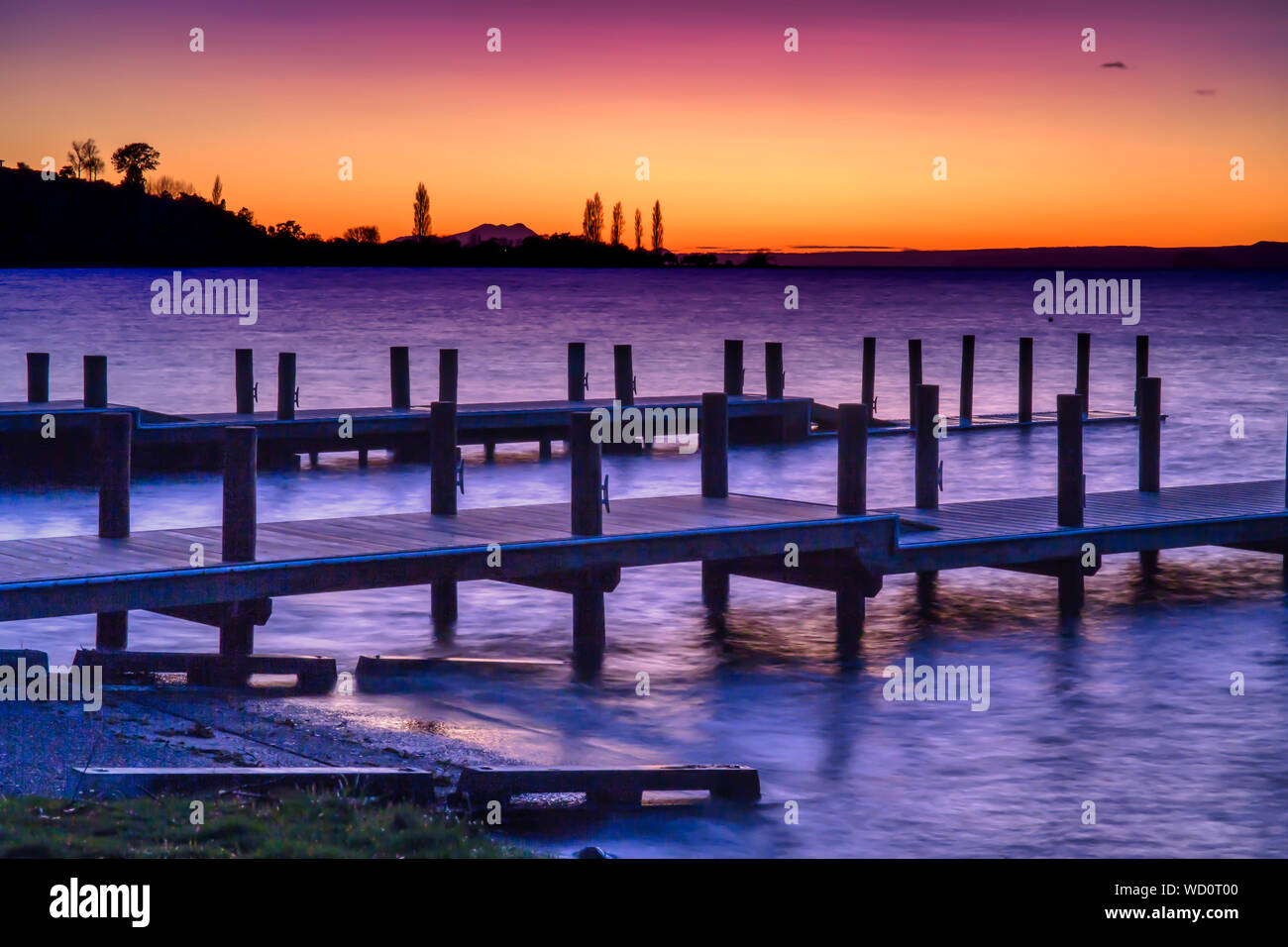 Dramatic colours of pre dawn over the piers and jetty at Turangi Lake Taupo New Zealand Stock Photo