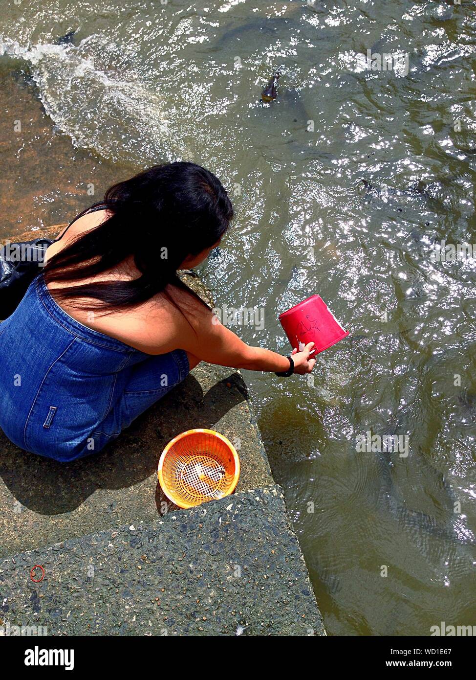 Woman with water bucket hires stock photography and images Alamy