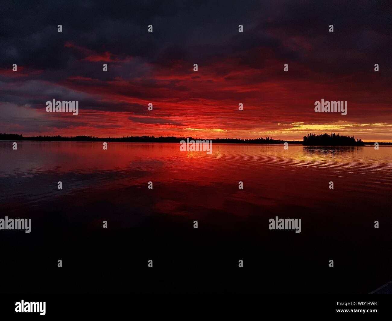 Scenic View Of Lake Against Orange Sky Stock Photo