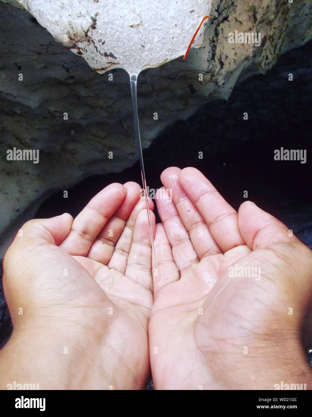 Cupped Hands Under Melting Glaciers Stock Photo