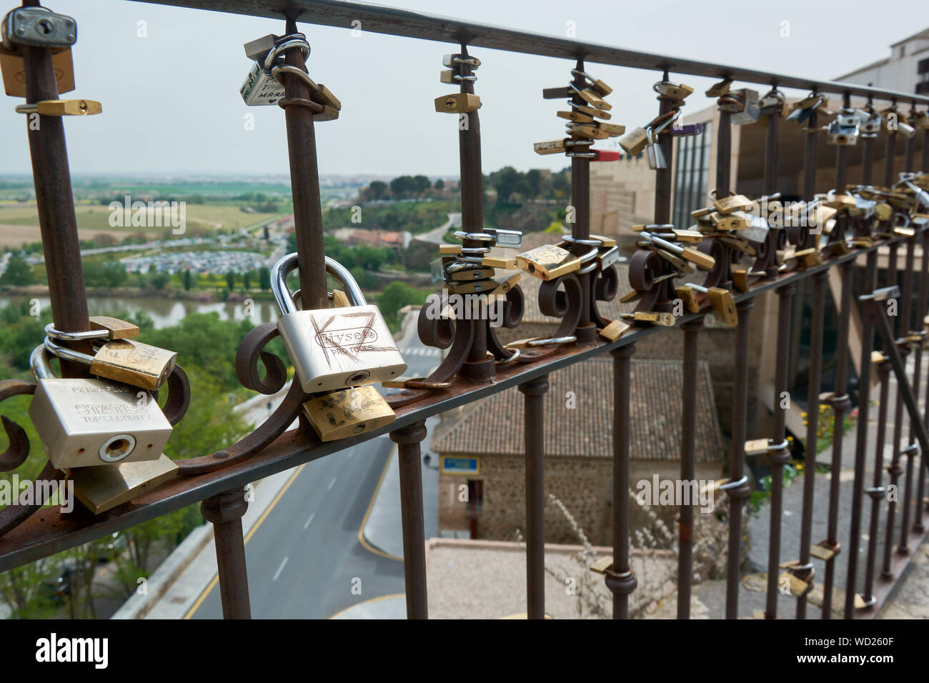 TOLEDO, SPAIN - APRIL 24, 2018: Locks of love in Toledo, hooked to a fence by lovers as a proof of eternal love. Stock Photo