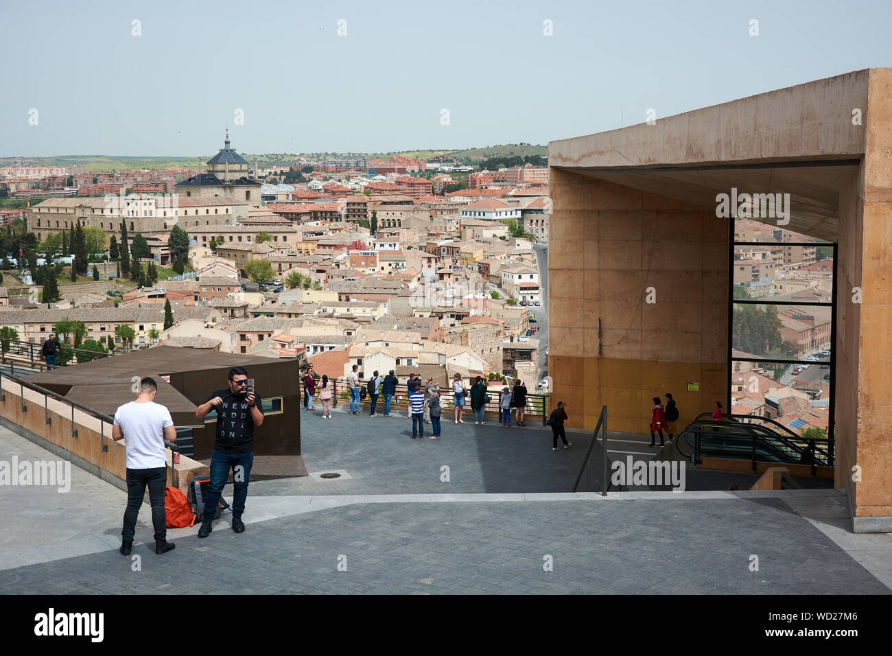 TOLEDO, SPAIN - APRIL 24, 2018: Tourists enjoying the day and cityscape in Toledo with a view of the Tavera Hospital in the background. Stock Photo