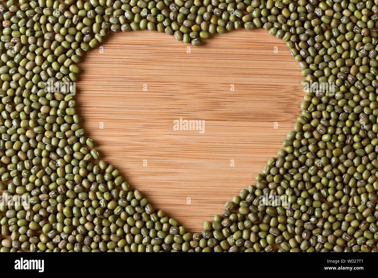 Directly Above View Of Mung Beans Arranged As Heart Shape On Wooden Table Stock Photo