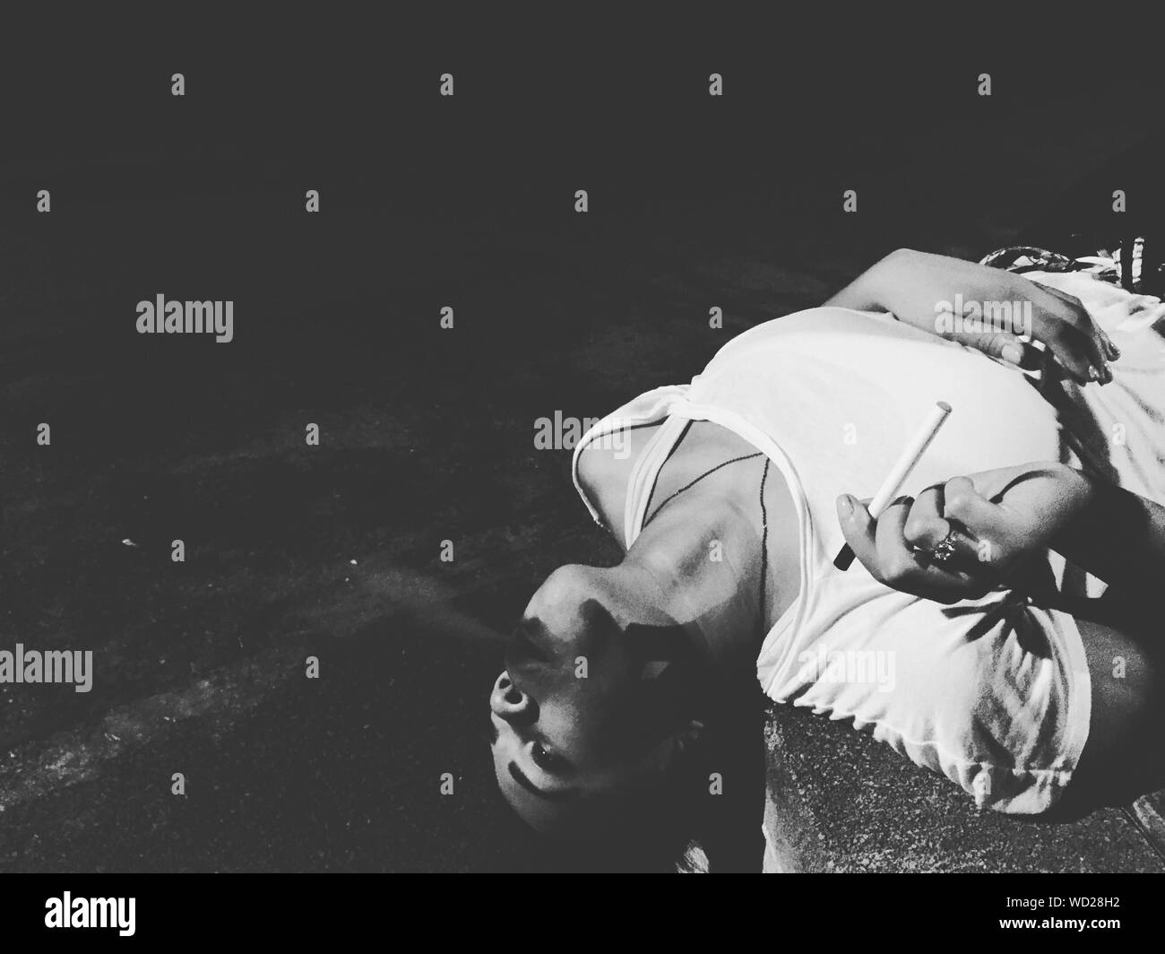 Woman Lying Down Smoking Cigarette High Resolution Stock Photography