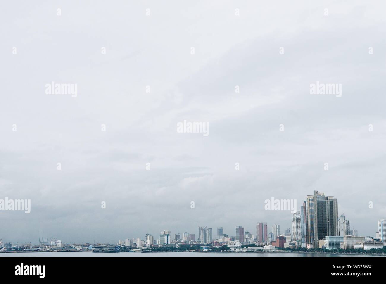 Cityscape By Manila Bay Against Sky Stock Photo