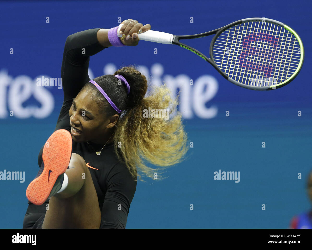 Flushing Meadow, United States. 28th Aug, 2019. Serena Williams kicks her leg up when she returns a ball to Catherine McNally in the 2nd round in Arthur Ashe Stadium at the 2019 US Open Tennis Championships at the USTA Billie Jean King National Tennis Center on Wednesday, August 28, 2019 in New York City. Photo by John Angelillo/UPI Credit: UPI/Alamy Live News Stock Photo