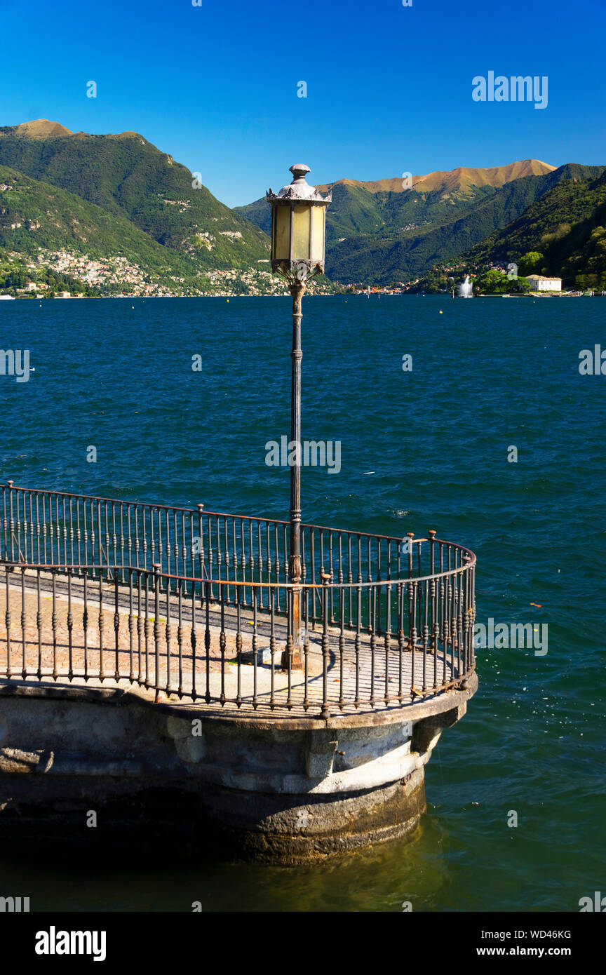 Electric Lamp On Pier At Lake Como Against Mountains Stock Photo