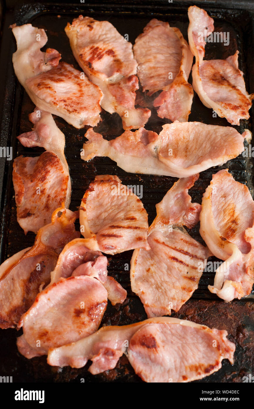 High Angle View Of Bacon On Griddle Stock Photo
