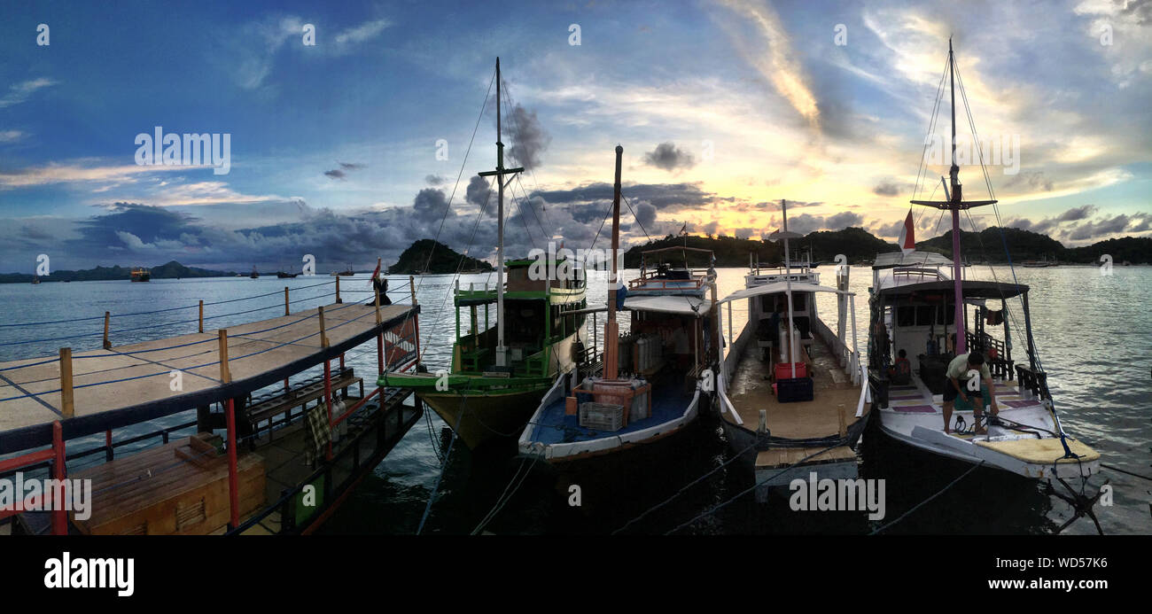Fishing Boats In Bay Against Sunset Sky In Labuan Bajo Stock Photo