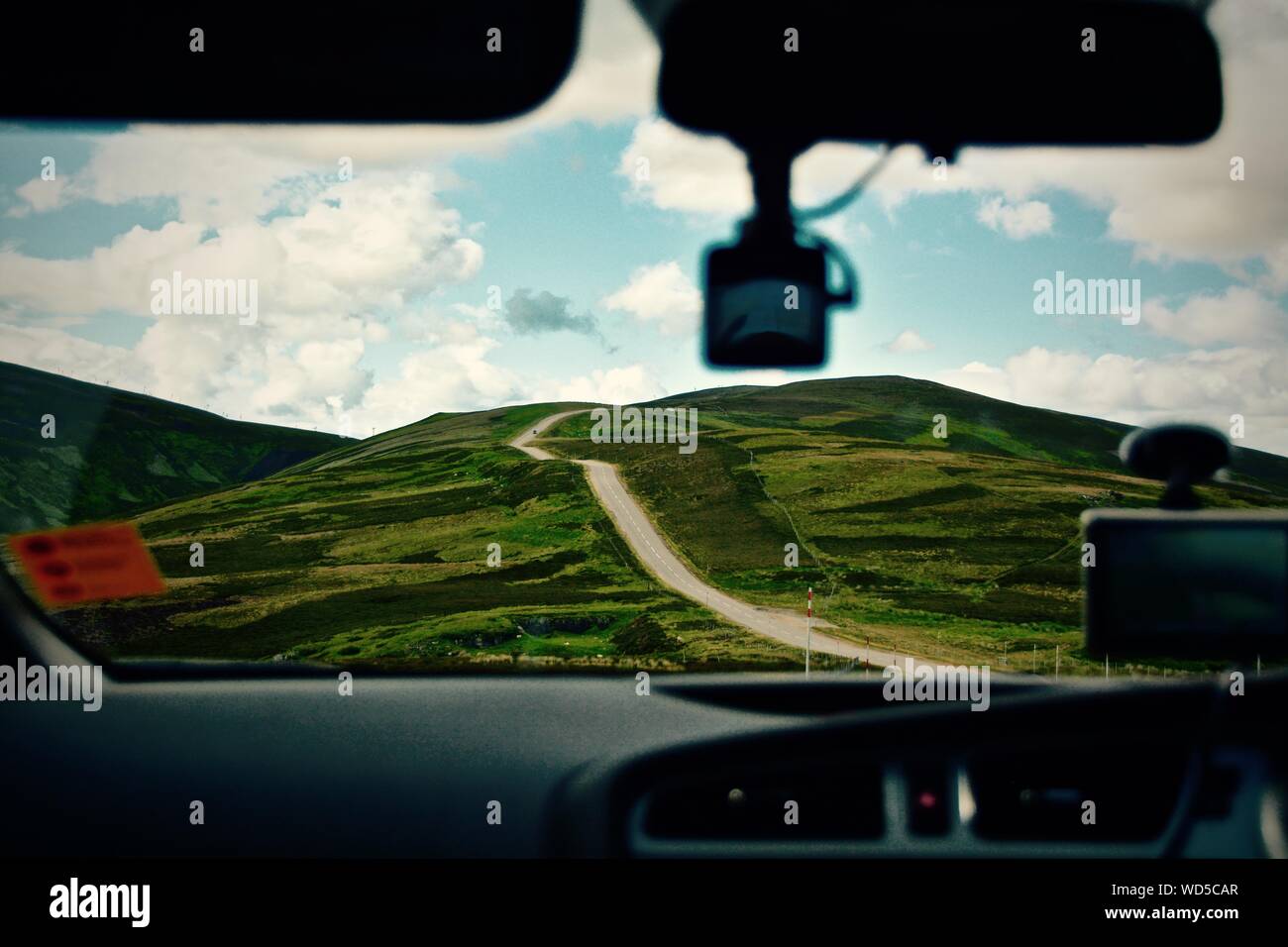 Country Road And Hilly Landscape View From Car Stock Photo
