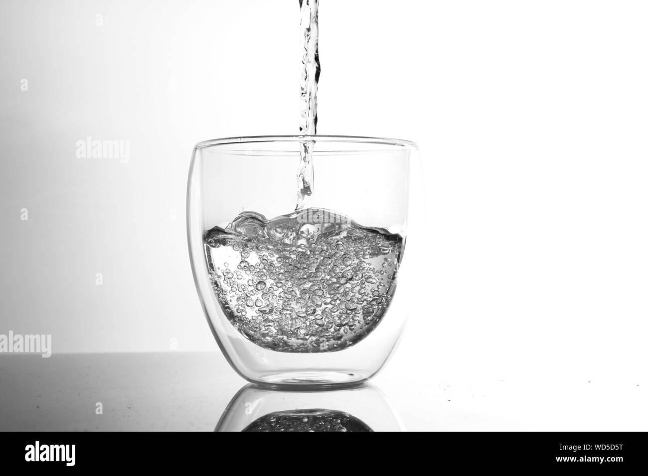 Glass of water white background Black and White Stock Photos & Images ...