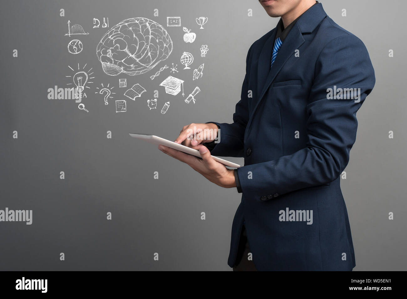 Digitally Generated Image Of Businessman Working On Tablet Against Gray Background Stock Photo