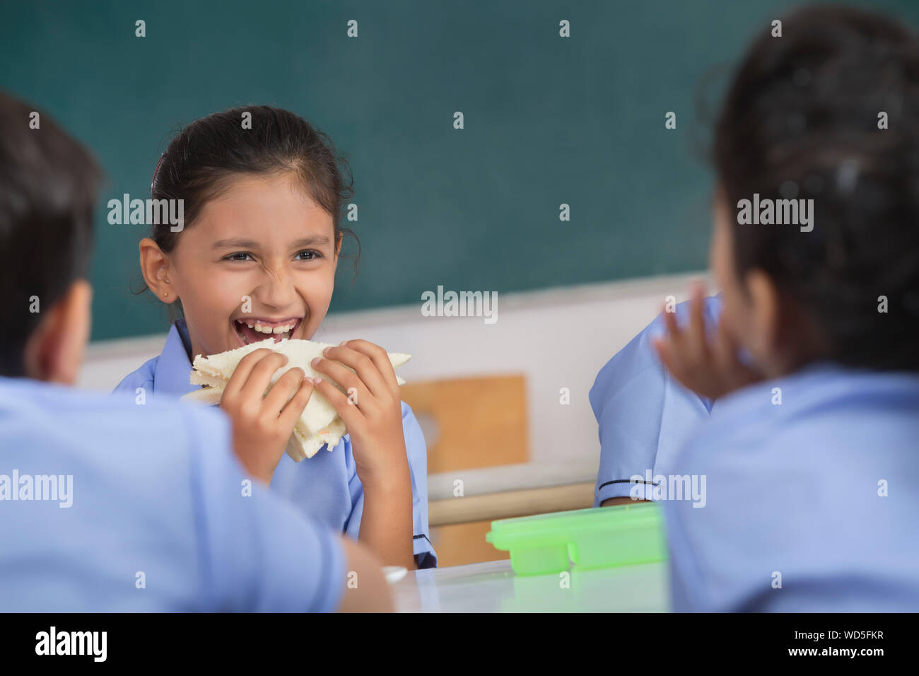 school girl eating sandwich in lunch Stock Photo