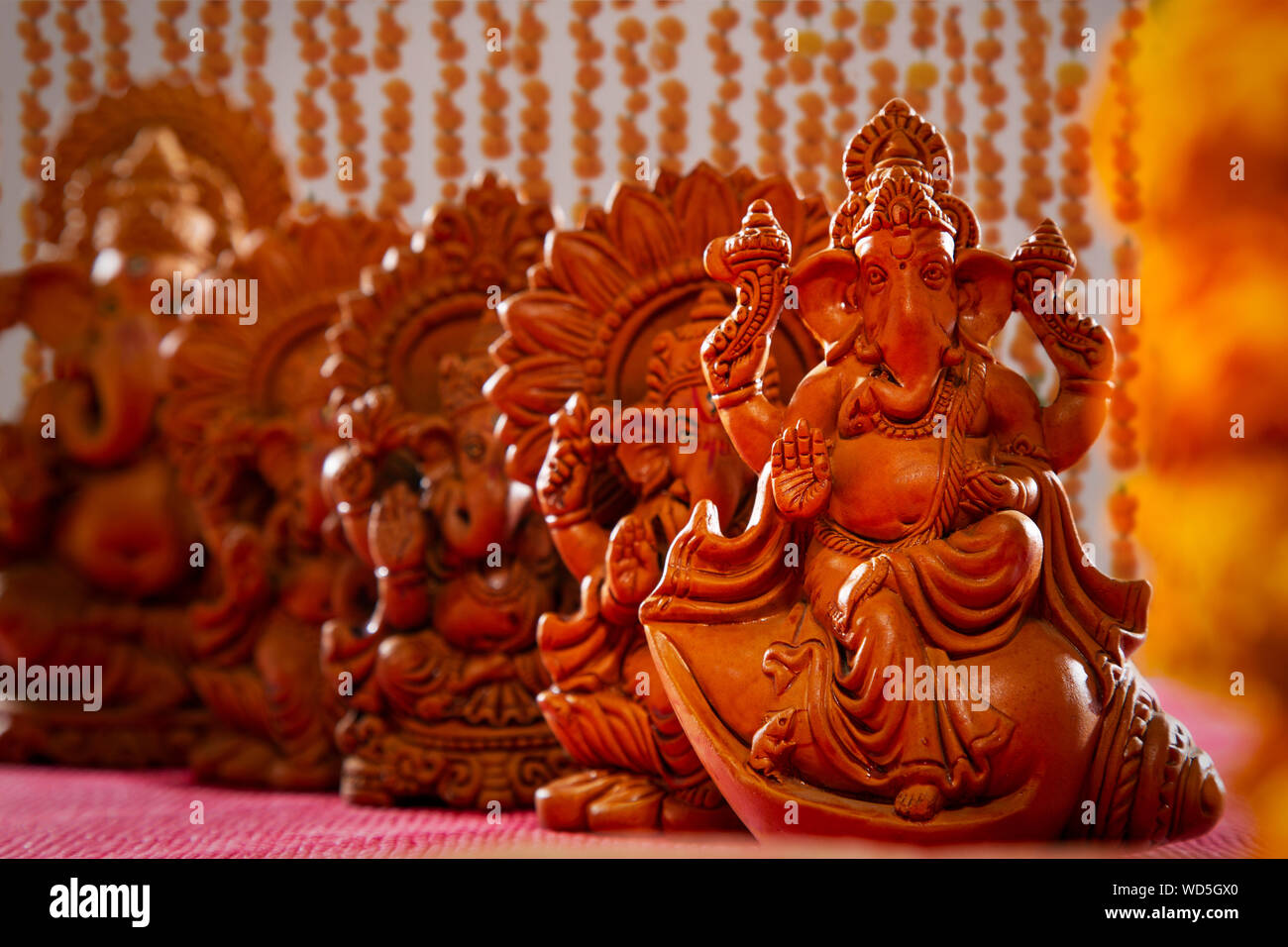 different types of ganesh idols kept on a table Stock Photo - Alamy