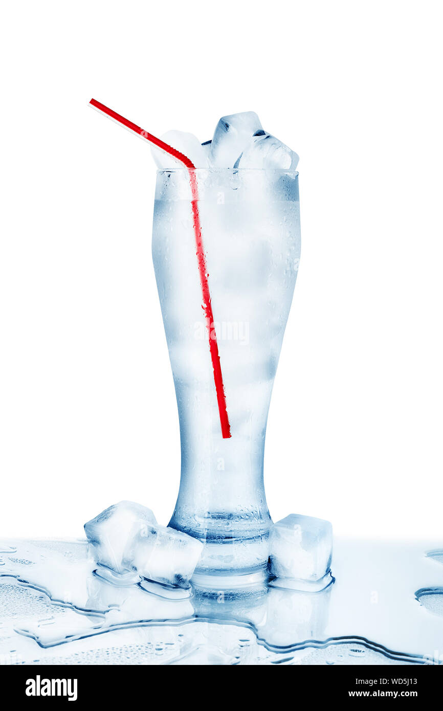 One full transparent glass of cold crystal clear water, red drinking straw, ice cubes condensation drops white background isolated close up reflection Stock Photo