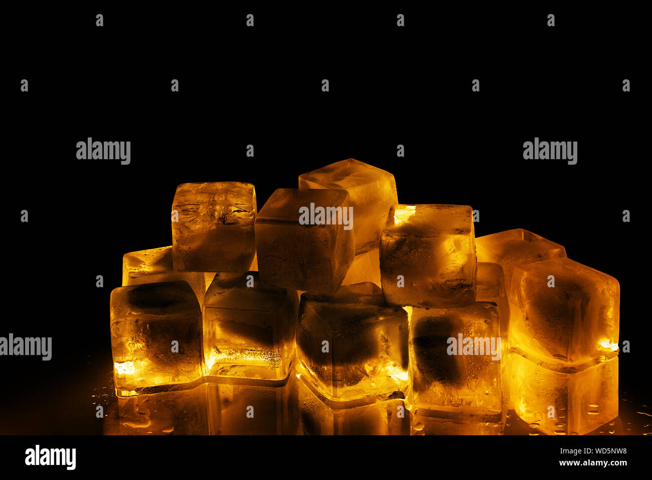 Download Golden Ice Cubes On Black Background Isolated Close Up Transparent Frozen Amber Color Water With Yellow Back Light And Reflection Cold Alcohol Drink Stock Photo Alamy Yellowimages Mockups